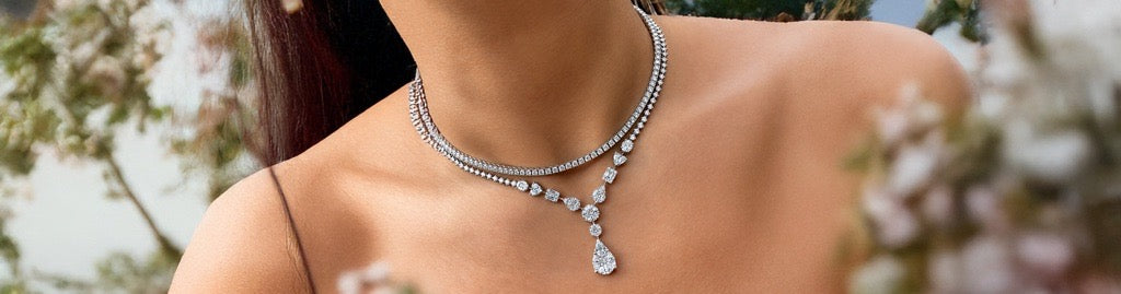 Layered diamond necklace with a pear-shaped diamond pendant drop