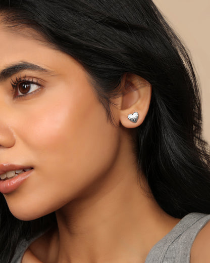 Woman wearing a Nadora Nove pavé diamond heart stud earring