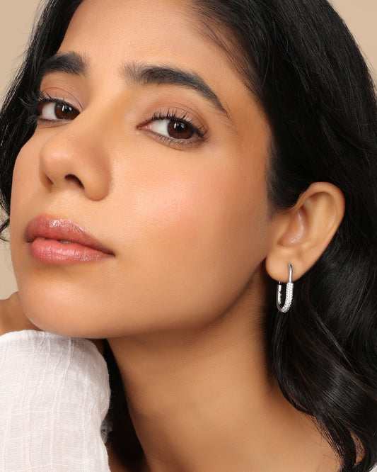Woman wearing a Nadora Nove diamond paperclip hoop earring, face turned in profile