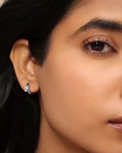 Woman wearing a Nadora Nove diamond huggie earring
