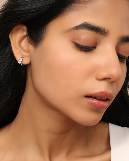 Woman wearing a Nadora Nove diamond huggie earring